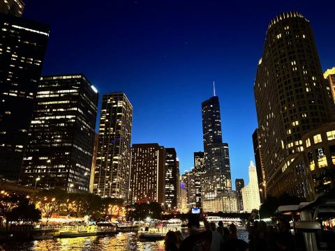 city of Chicago at night taken from the Chicago River on a boat